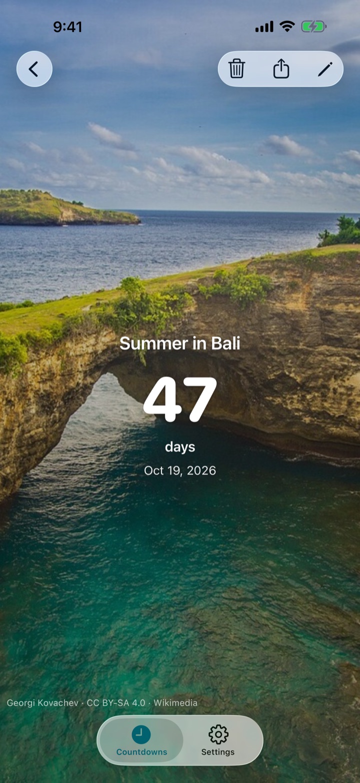 A countdown screen showing “Summer in Bali”, 47 days, over a photo of the Nusa Penida coast.